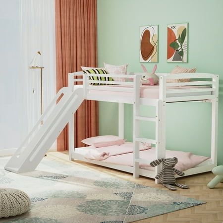 there is a bunk bed with a slide on the bottom and a rug underneath it