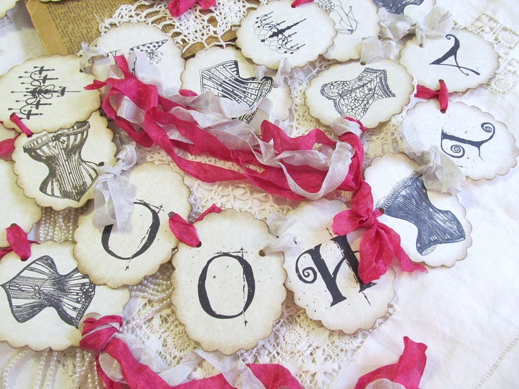 some cookies are laying on a table with ribbons around them and tags that say love