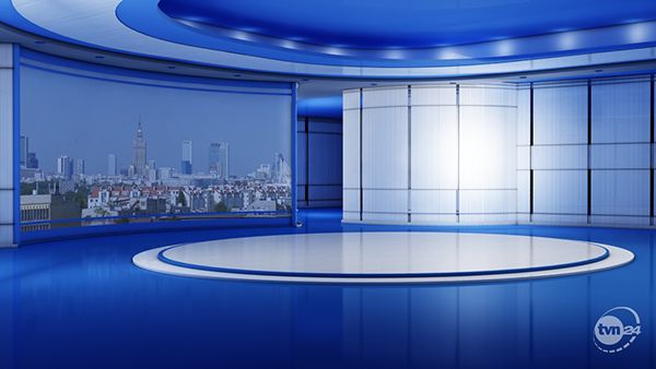 an empty tv studio with blue and white paint on the walls, in front of a cityscape