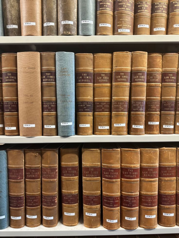 several rows of old books on shelves in a book store, with one being blue and the other is brown