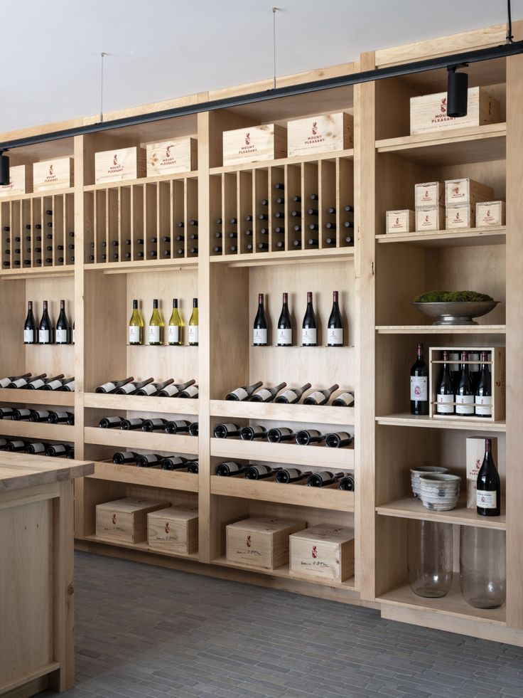 a wine shop with wooden shelves filled with bottles