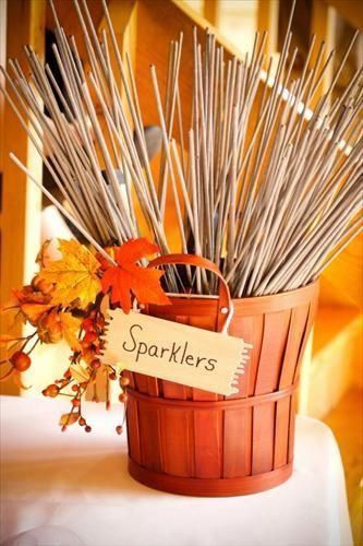 a basket filled with lots of sticks sitting on top of a table next to a sign