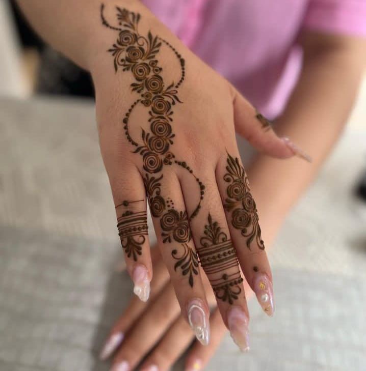 a woman's hand with henna tattoos on it