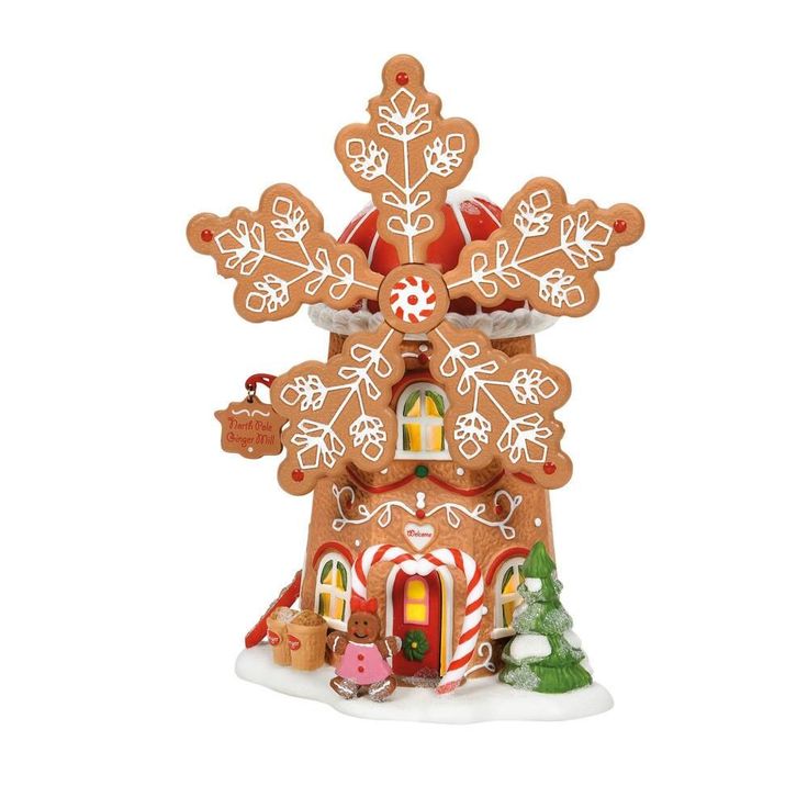 a gingerbread house with snowflakes and candy canes on the roof is shown