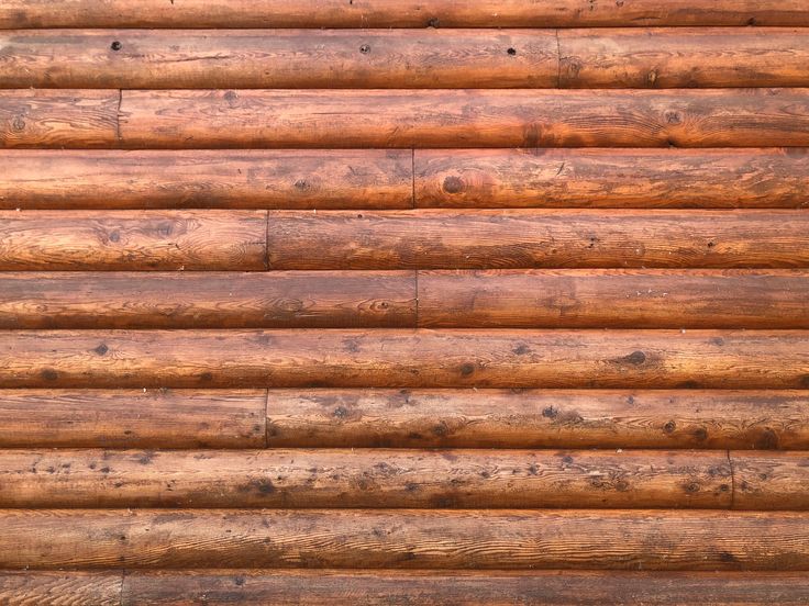 a close up view of a wooden wall made out of wood planks and logs