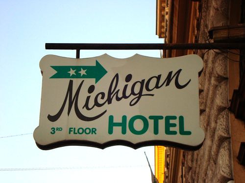 the michigan hotel sign is hanging from the building