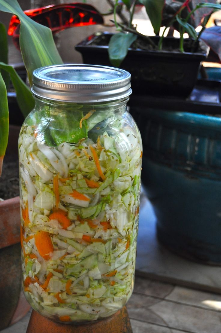 a mason jar filled with coleslaw and carrots