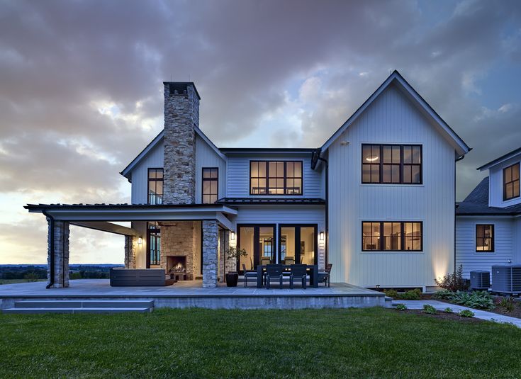 a large white house sitting on top of a lush green field