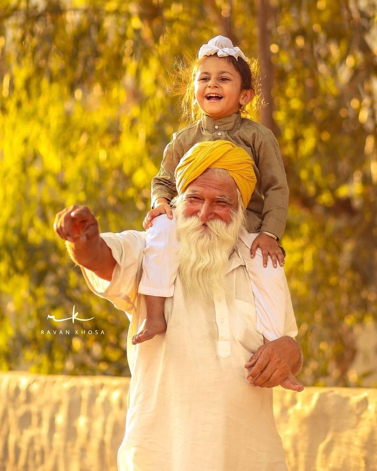 an old man carrying a child on his shoulders