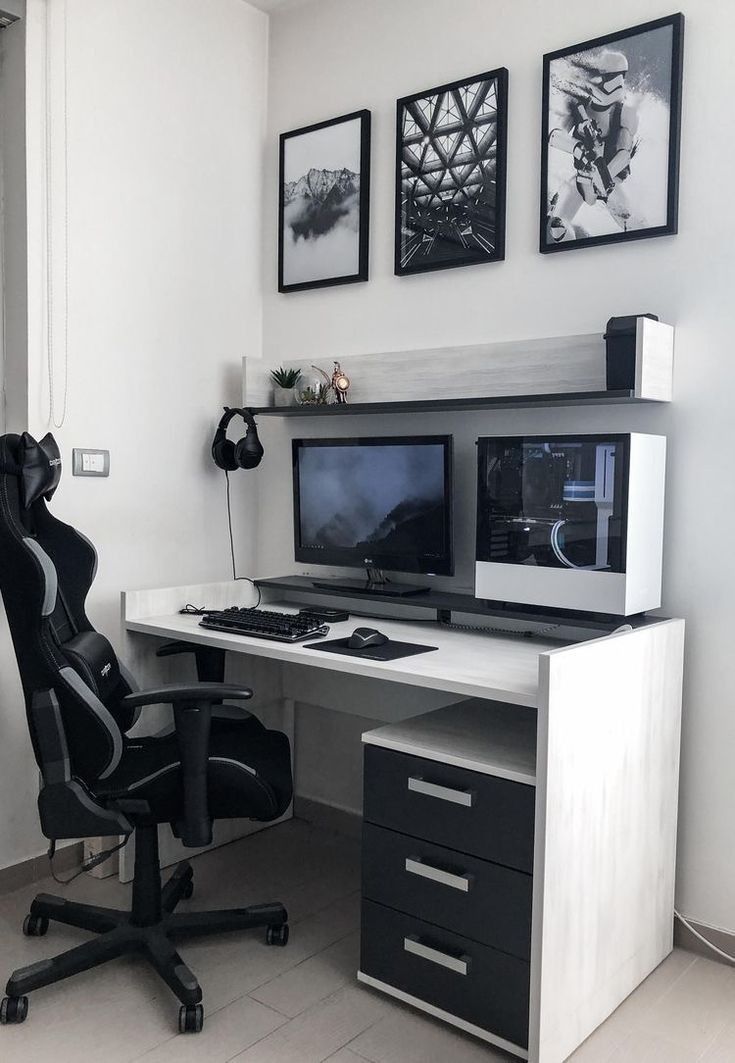 a desk with two computer monitors and a black chair in front of the monitor screen