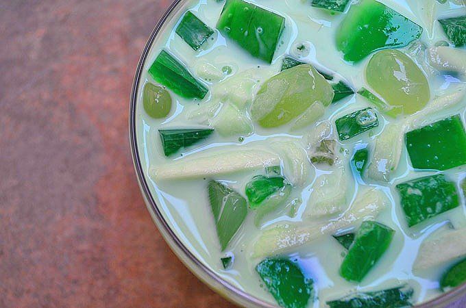 a glass bowl filled with green and white liquid