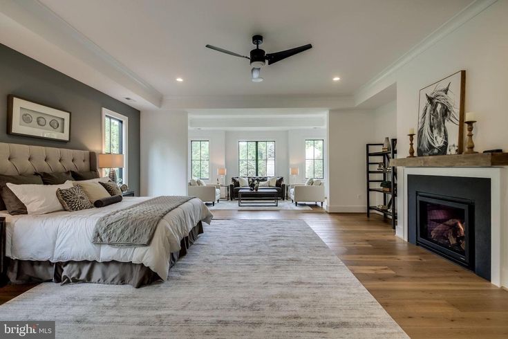 a large bedroom with a fireplace and bed in it