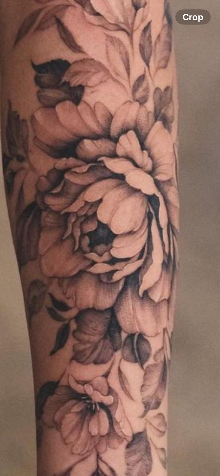 a woman's leg with black and white flowers on it