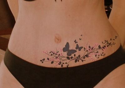 a woman with butterfly tattoos on her stomach