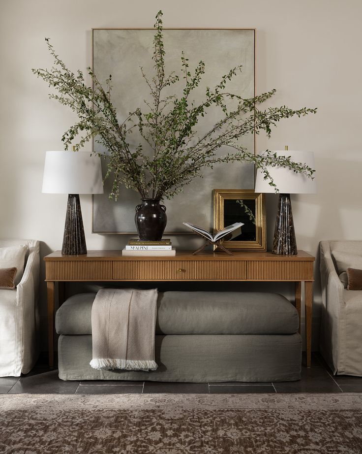 a living room filled with furniture and a painting on the wall