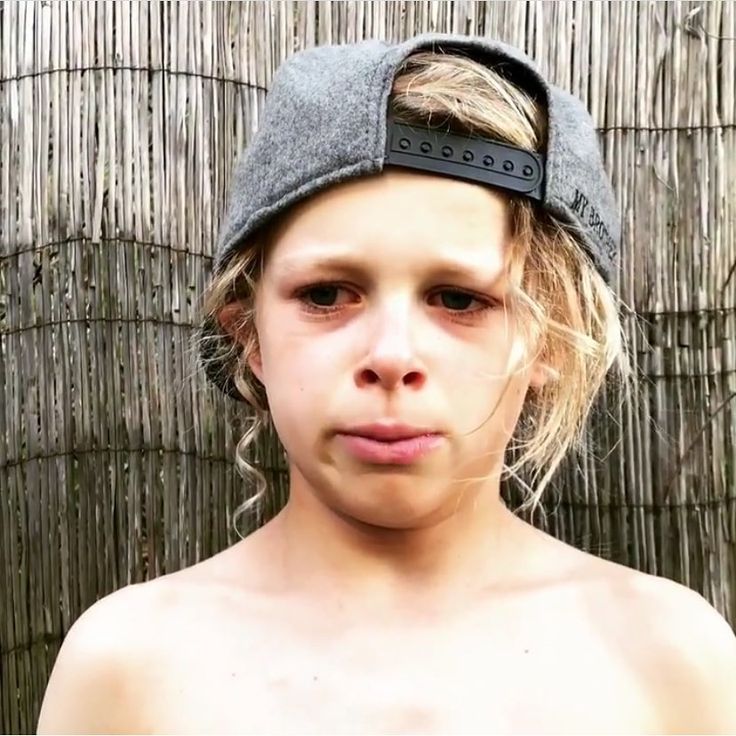 a young boy wearing a hat and no shirt