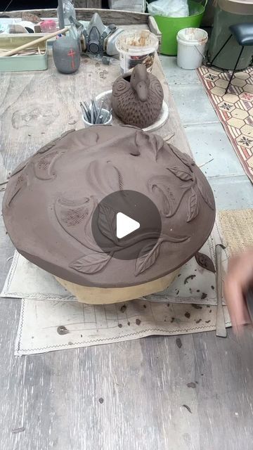 a person is working on an object with clay