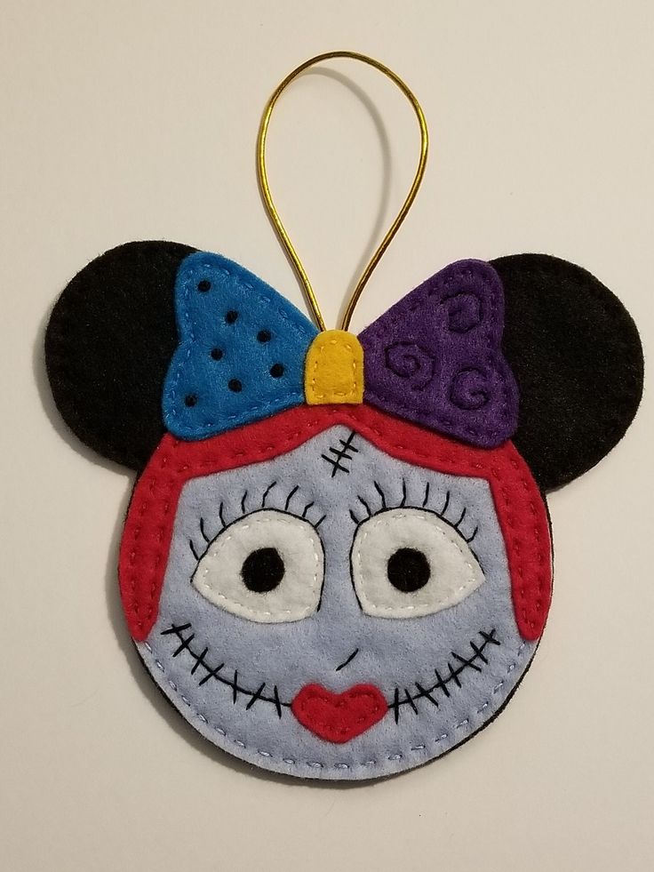 a mickey mouse ornament hanging on a wall