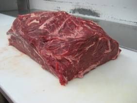 a piece of meat sitting on top of a cutting board