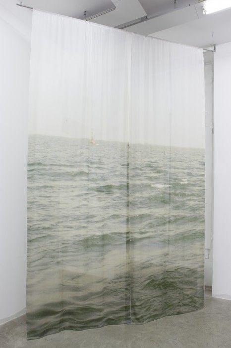 an open room with curtains that have water on them