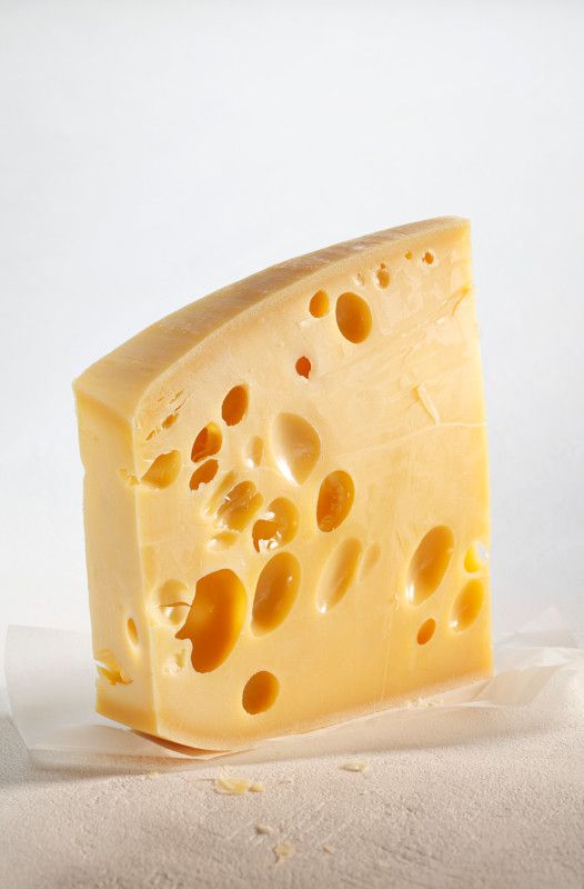 a piece of cheese with holes in it