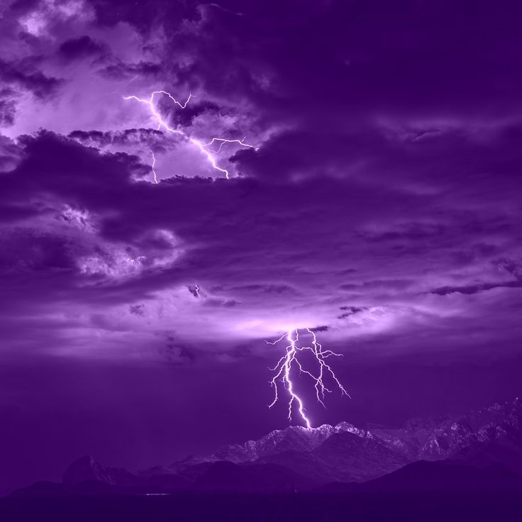 a purple sky filled with lightning and clouds