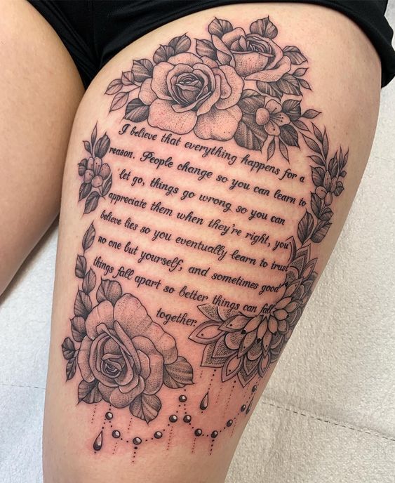 a woman's thigh with flowers and a poem written on the back of her leg