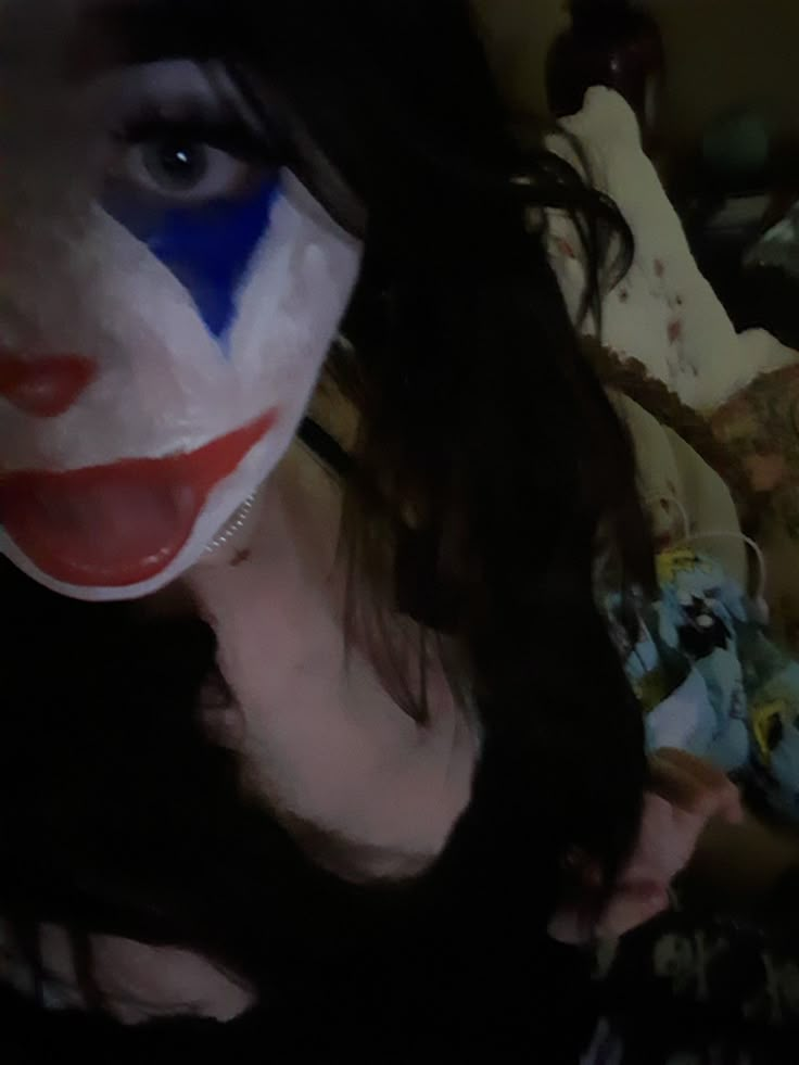 a woman with her face painted like a clown