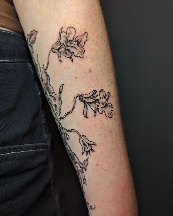 a person with a flower tattoo on their arm