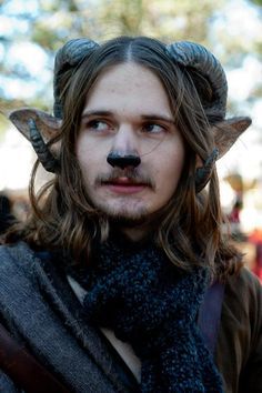 a man with long hair and horns on his head