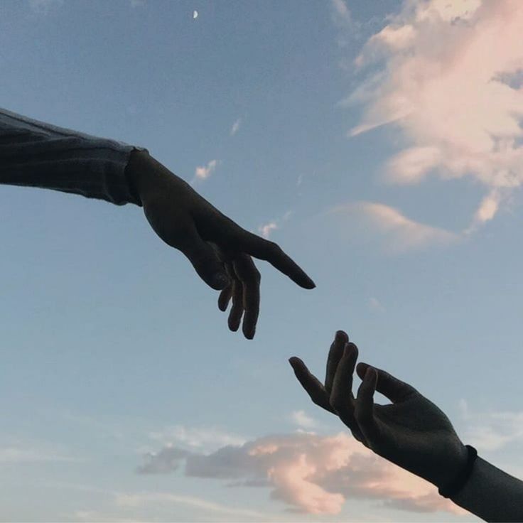 two hands reaching out towards each other in the sky