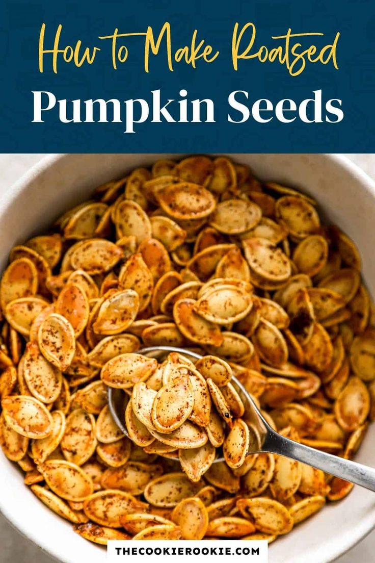 how to make roasted pumpkin seeds in a white bowl with a spoon and title overlay