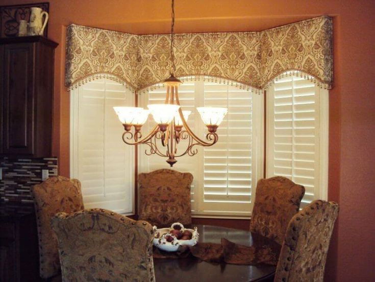 a dining room table with chairs and a chandelier