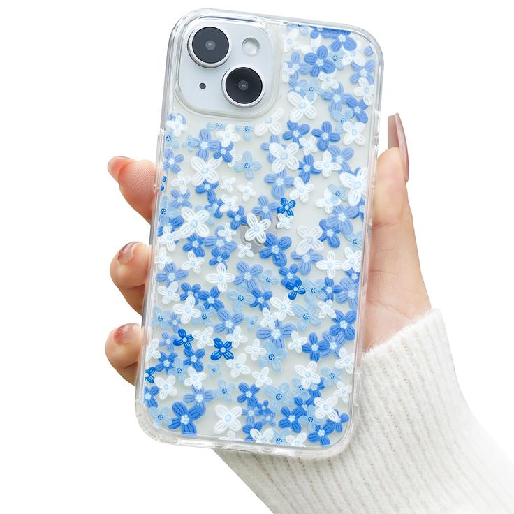 a person holding an iphone case with blue and white flowers on it in their hand