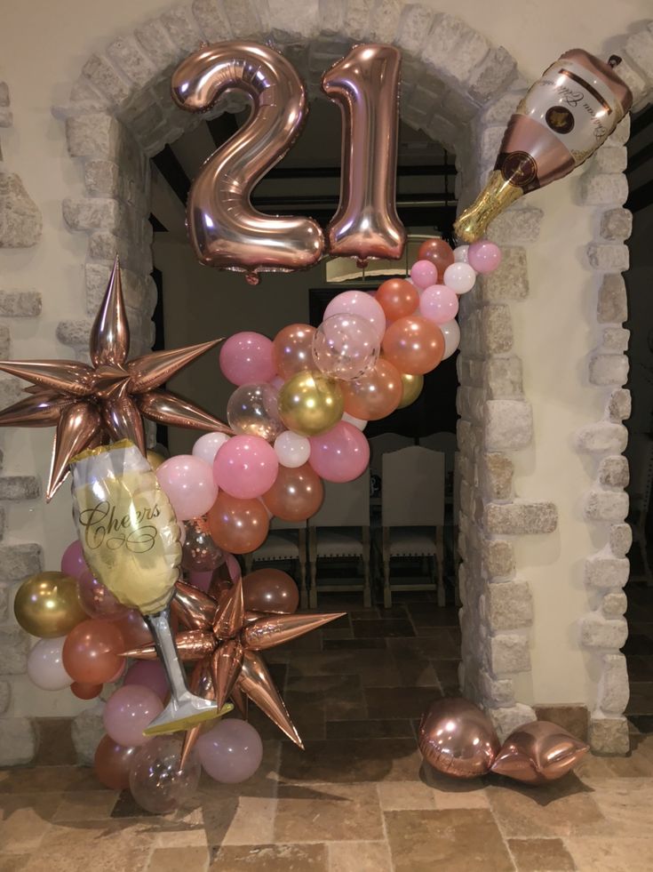 the balloon arch is decorated with balloons and star decorations for an entrance to a party