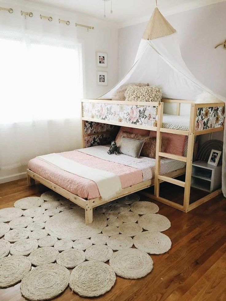 a child's bedroom with a bed and rugs on the floor