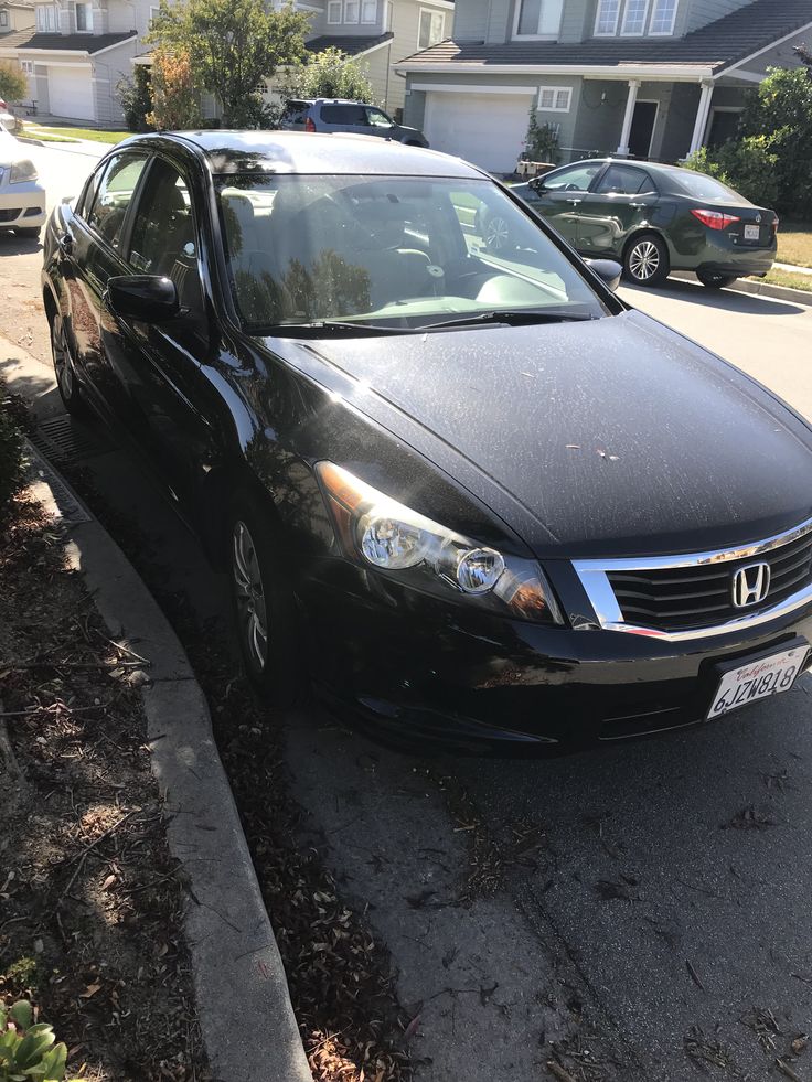 a black car parked in front of a house