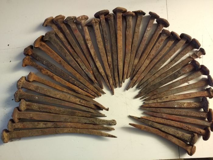 an assortment of old nails arranged in a circle