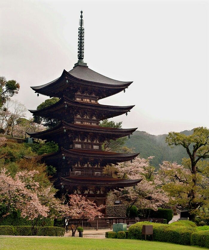 a tall pagoda in the middle of a park