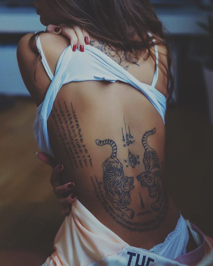 a woman with tiger tattoos on her back