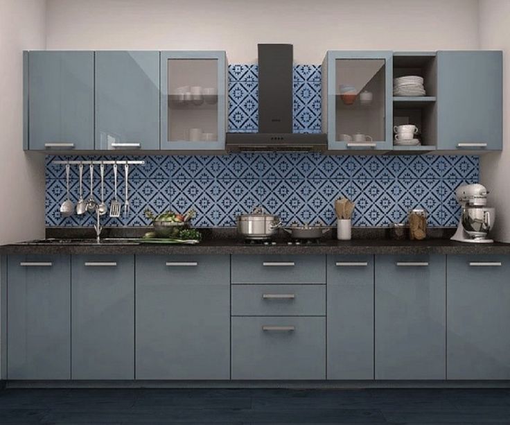 a kitchen with blue cabinets and black counter tops on the wall, along with pots and pans