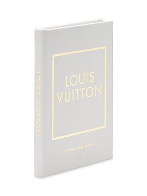 the louis vuitton book is shown in white and gold on a white background