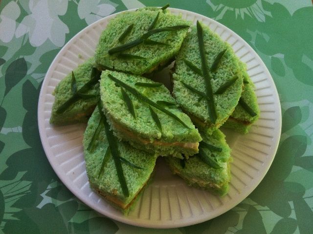 some green leaf shaped food on a white plate