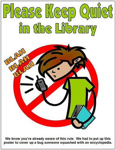 a poster with the words please keep quiet in the library and a person holding a book