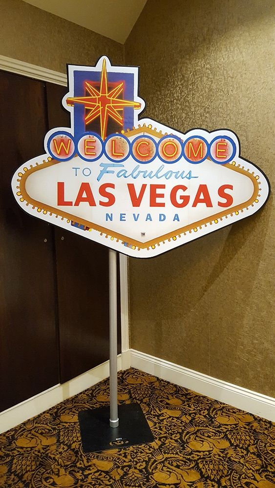 the welcome sign to las vegas is on display in front of a wall and carpet