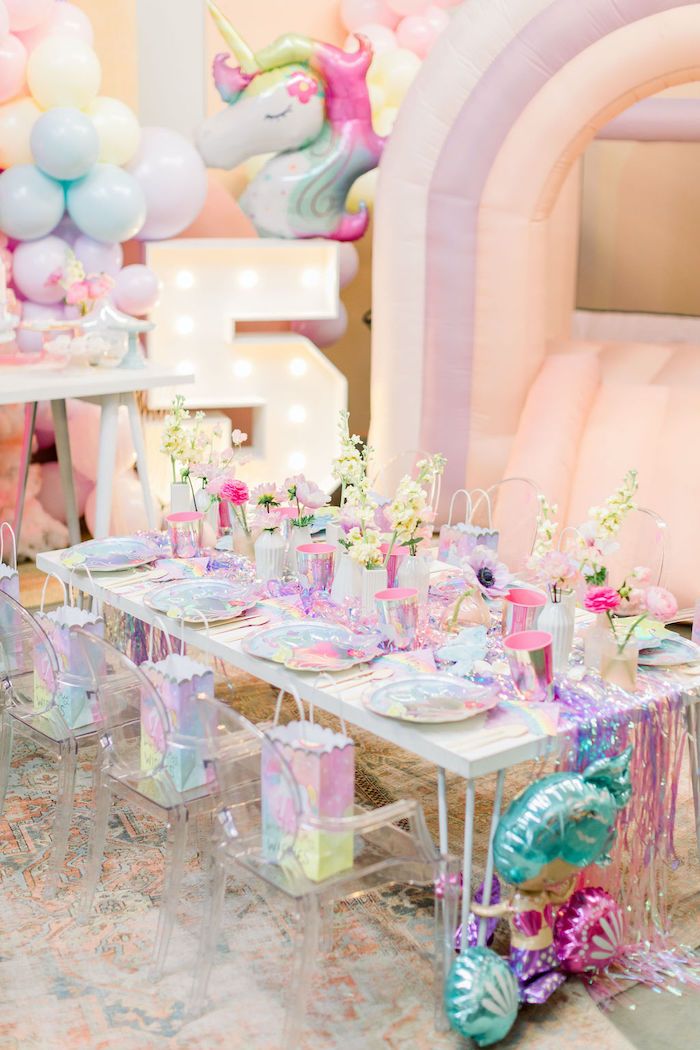 a table set up for a unicorn themed birthday party