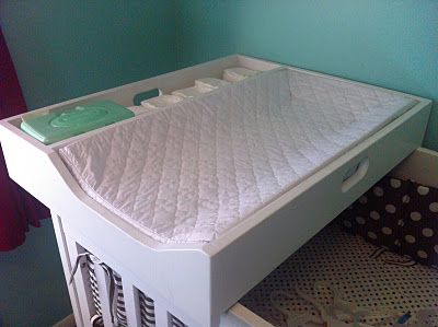 a baby crib with a mattress on top of it