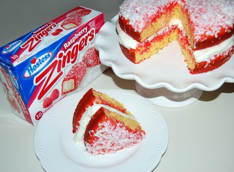 a piece of cake sitting on top of a white plate next to a box of candy