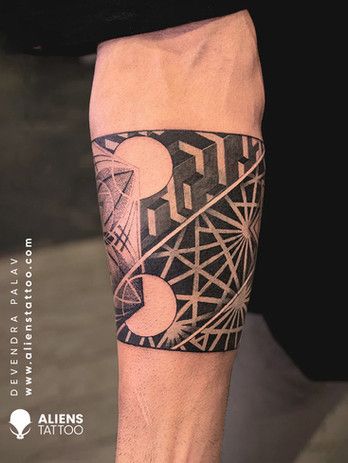 a man's arm with an abstract tattoo design on the forearm and leg area