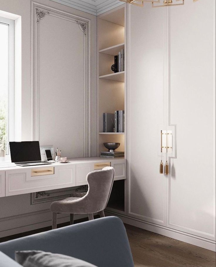 a laptop computer sitting on top of a white desk next to a chair in front of a window